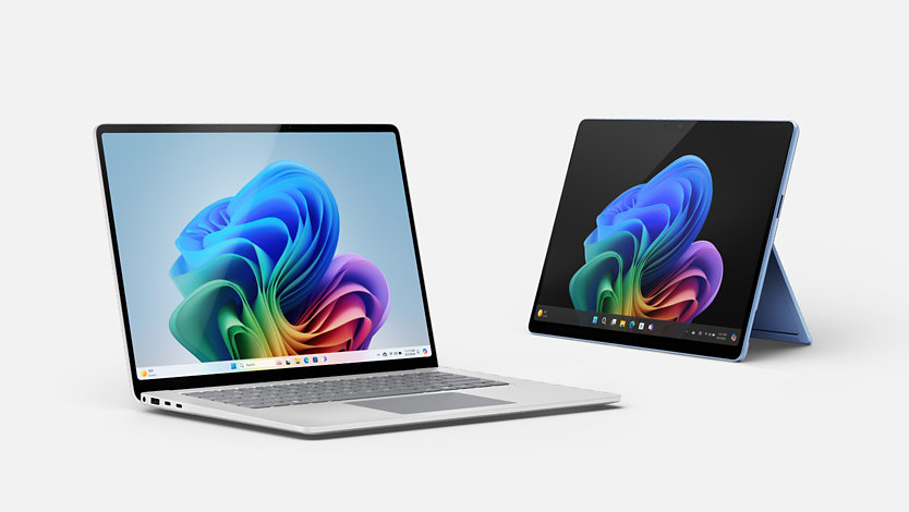 A platinum Surface Laptop and a sapphire Surface Pro.