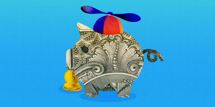 A piggy bank made out of cash with coins and a child's propeller hat representing kids' savings accounts against a blue background